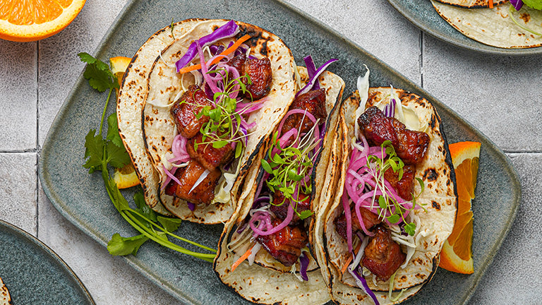 Crispy Smoked Kurobuta Pork Belly Tacos with Serrano-Orange Glaze and Pickled Red Onions