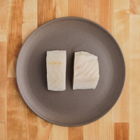 Two halibut filets on plate.